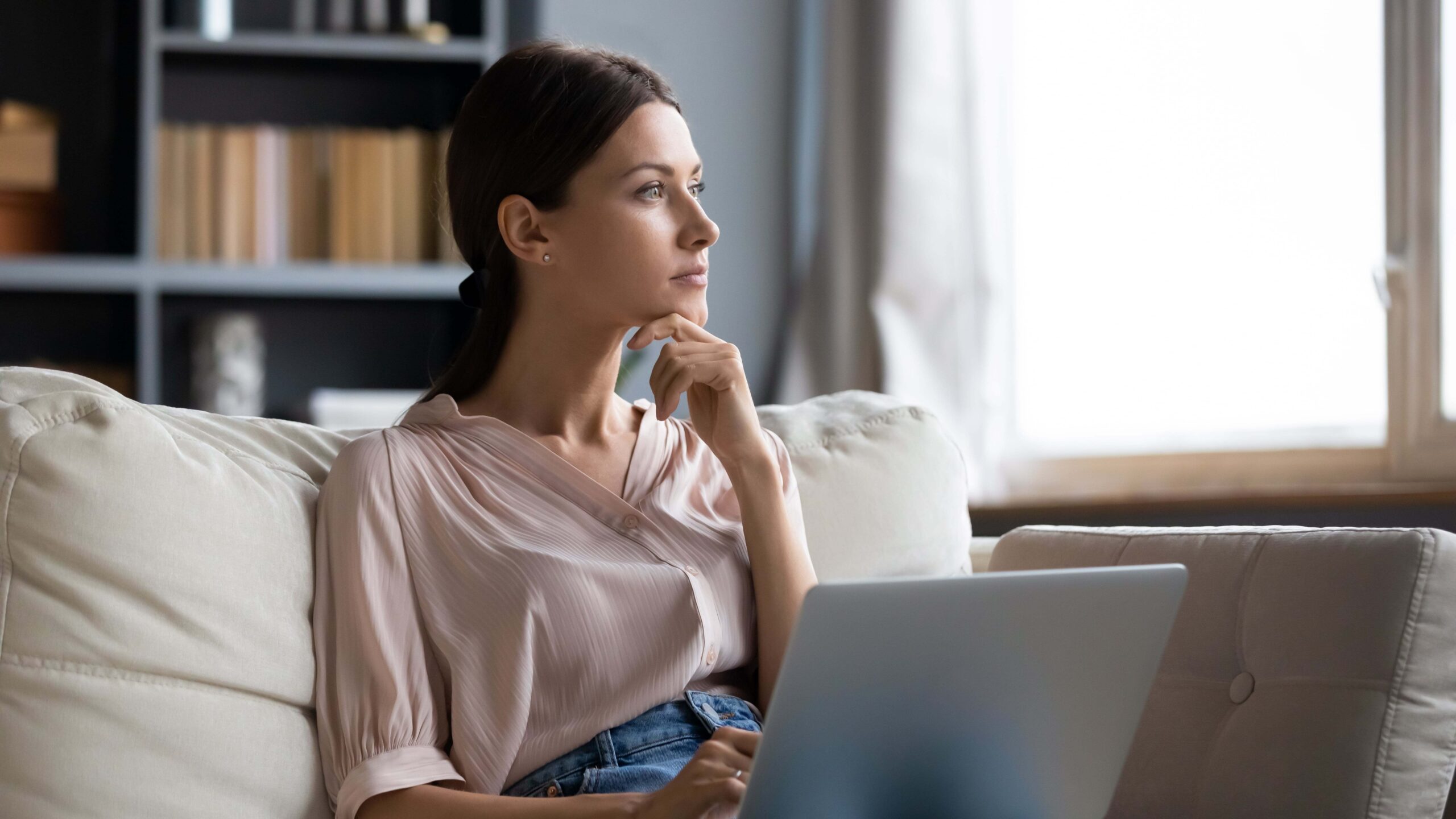 Woman thinking about choosing between rent reporting agencies - Blog cover photo