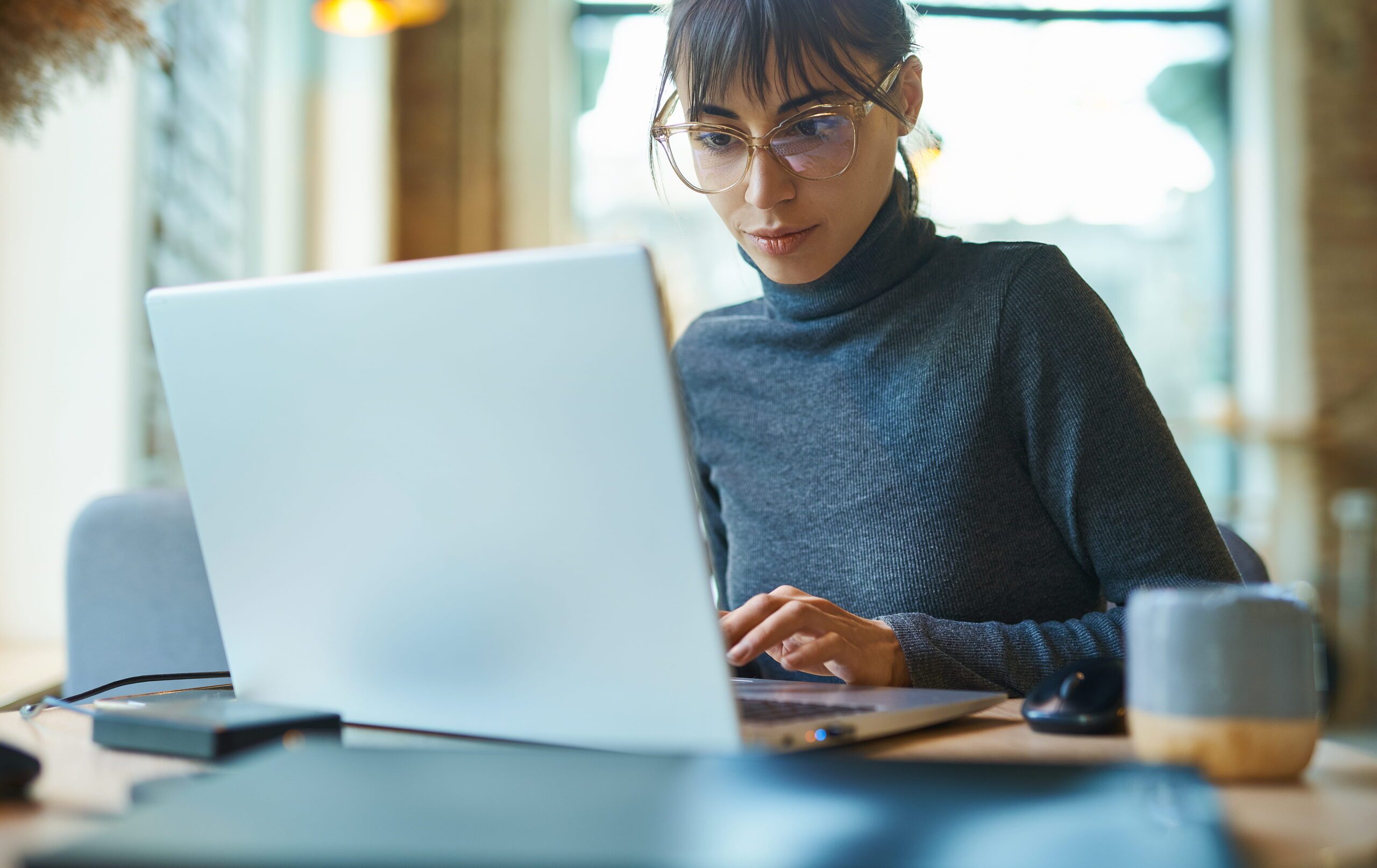Female Tenant disputing Rent Reporting on laptop.